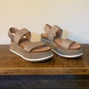 Platform sandals in neutral browns and slight metallic look.